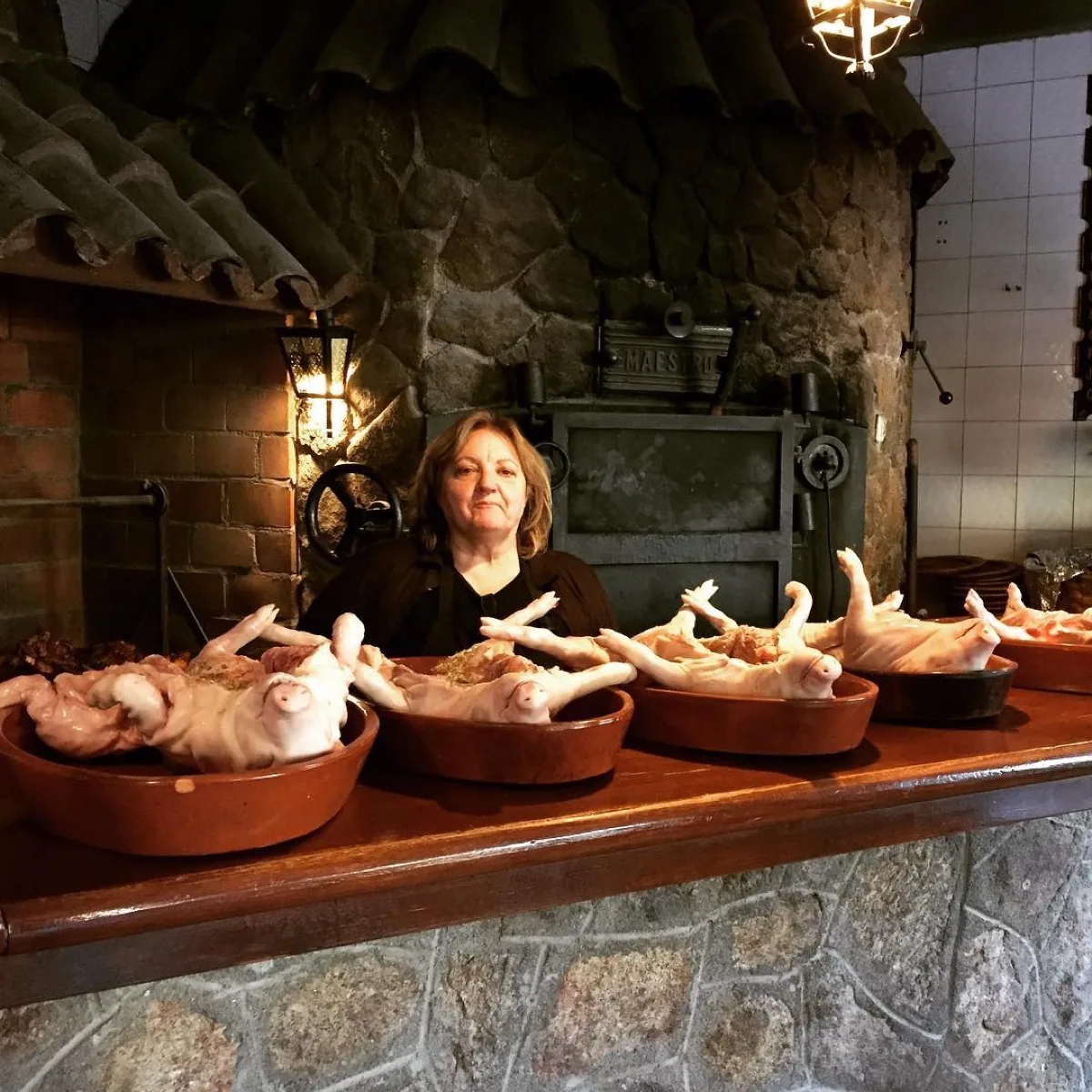 La familia del Asador Asomadilla ante el horno de leña
